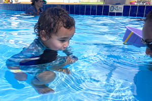 young Aboriginal boy blowing bubbles in a pool