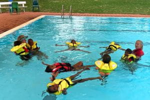 Jigalong kids wearing lifejackets and learning water safety at the Jigalong pool