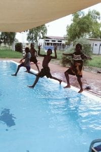 Aboriginal children stepping into the pool
