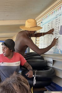Jigalong Youth Team recording the Swim for Fruit lap tallies on the tally board