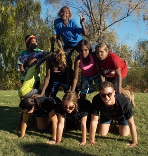 aboriginal children with Fairgame leaders building a human pyramid