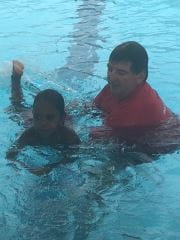David with a child in the pool 