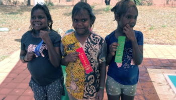 Three aboriginal girls with their swimming place ribbons