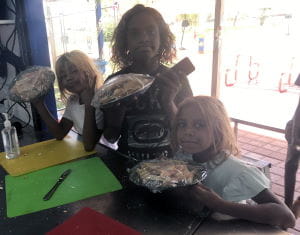Three Aboriginal girls with plates of fairy bread