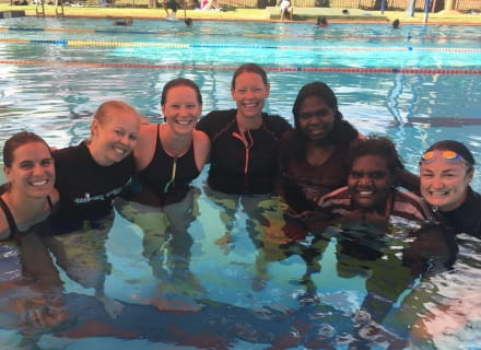 a group of seven women in the water completing swim instructor training in Newman