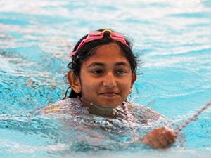 young girl participating in a line throw relay