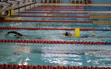 A competitor pulling a teammate in a rescue tube relay