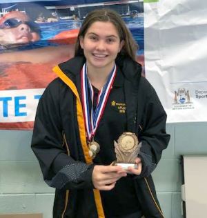 Lily Moore with her medal and trophy from the JLC State Titles