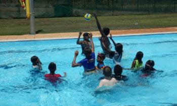 Aboriginal children from Warmun enjoying pool games in the community's swimming pool