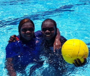 Two Kalumburu teenagers in the pool with a water polo ball