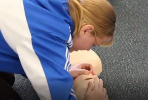 a girl practising CPR