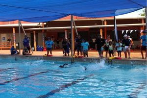 Aboriginal children starting a swimming race in a pool