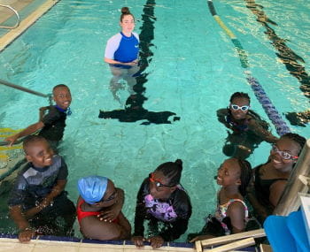 Kenyan children in the pool with their swim instructor