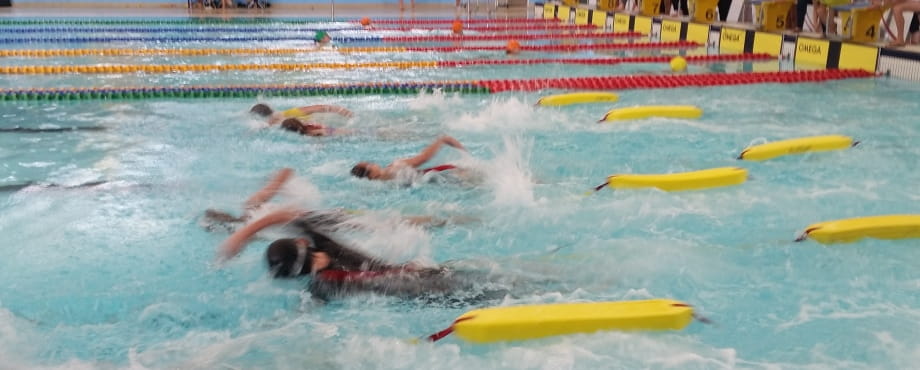 image of students swimming with rescue tubes