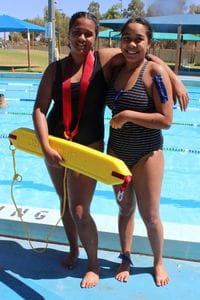 Two girls at pool with rescue tube
