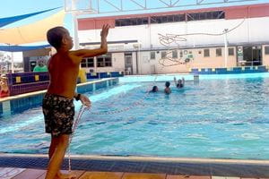 boy practising a rope throw at the Leonora swimming pool