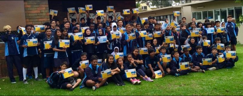 Multicultural children at Lynwood Senior High School showing off their Swim and Survive certificates