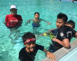 Multicultural boys with their swim instructor in the pool at Lynwood