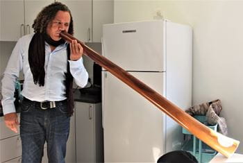 Noongar man Dennis Simmons playing the didgeridoo