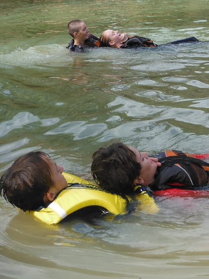 two boys practising a river rescue on their teammates