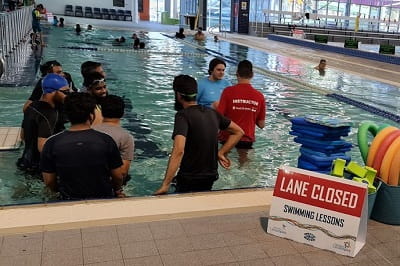 men at a men's only swimming lesson in a public pool