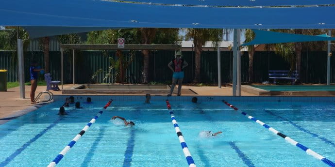 kids swimming in the Mount Magnet pool with instructor looking on