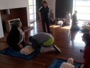 Royal Life Saving community trainer Marion, teaching CPR skills to a group of parents and carers