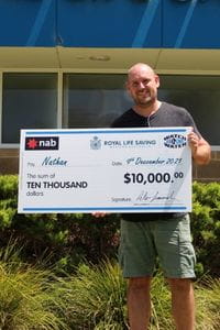 Raffle winner Nathan with his giant winner's cheque