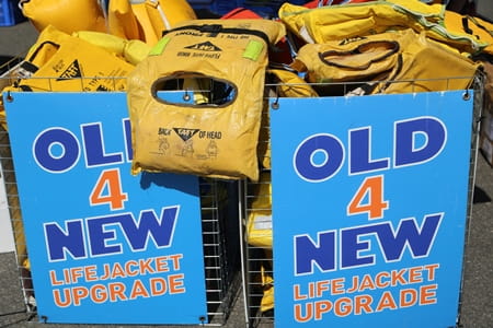 two containers of old lifejackets with the Old4New logo on the front