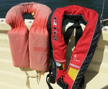 old lifejacket with a new style lifejacket on the edge of a boat