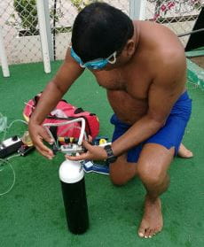 a lifeguard practising use of an oxygen bottle