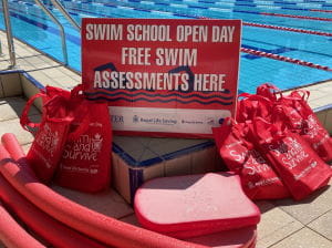 Swim School Open Day signage and equipment by the pool