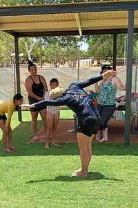 Instructor Cathie Calleja teaching students on the grass at Pannawonica pool