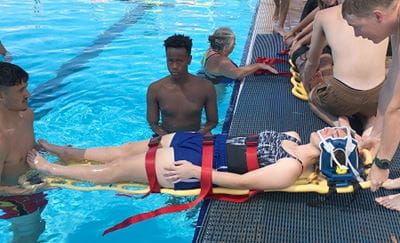 lifeguard students practising a spinal rescue