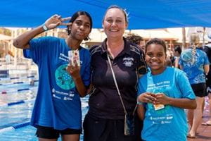 two students standing with a teacher at the 2023 Pilbara Spirit Carnival