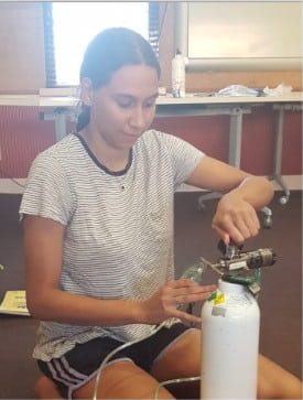 lifeguard student preparing an oxygen bottle
