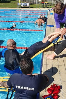 Pool Lifeguard Trainers practising a spinal rescue