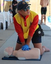 A team member from Adventure World performing CPR on a manikin