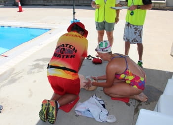 image of two lifeguards performing CPR on a manikin