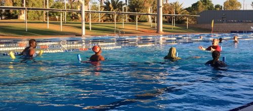 Multicultural women in the pool with their instructor at Port Hedland