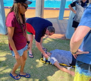 Pool managers practising lifesaving skills