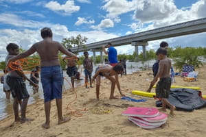 Aboriginal children learning rescue skills at a river