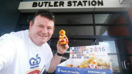 Volunteer at Butler Train Station with Quackers merchandise and collection duck