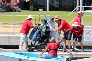 Assisting sailability participant getting on a boat