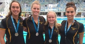 Madeline Thompson, Alicia Anderson, Chalice Pratt and Maddi Howe with their medals by the pool