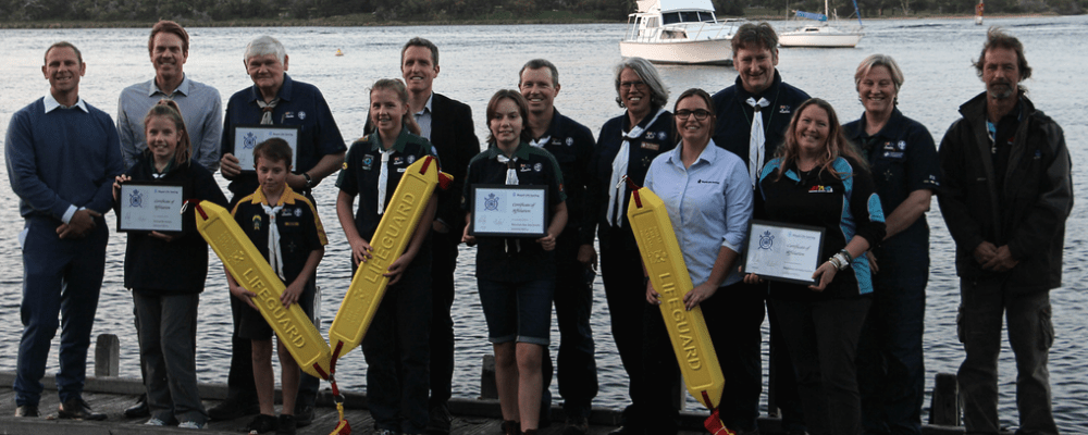 Sea scouts awards presentation in front of water body