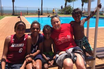 4 aboriginal children with Royal Life Saving Society WA's Jen Mickle by the pool in Port Hedland