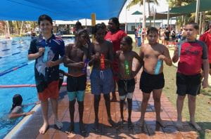 6 boys by the pool with their place ribbons at Gratwick Aquatic centre
