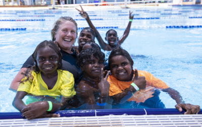 Aboriginal children with a swim instructor in the pool