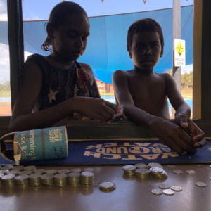 Children counting coins at the Bidyadanga Pool
